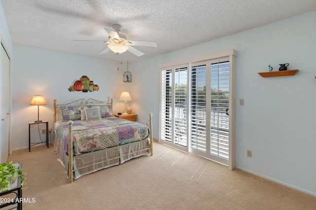 carpeted bedroom featuring a textured ceiling and ceiling fan