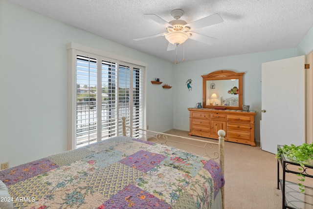 carpeted bedroom with a textured ceiling and ceiling fan