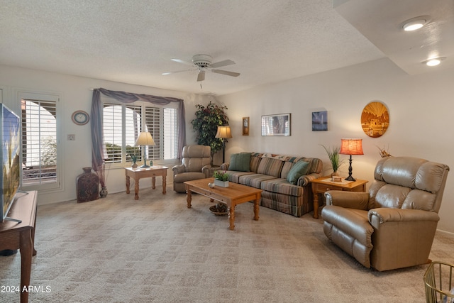 carpeted living room featuring a textured ceiling and ceiling fan