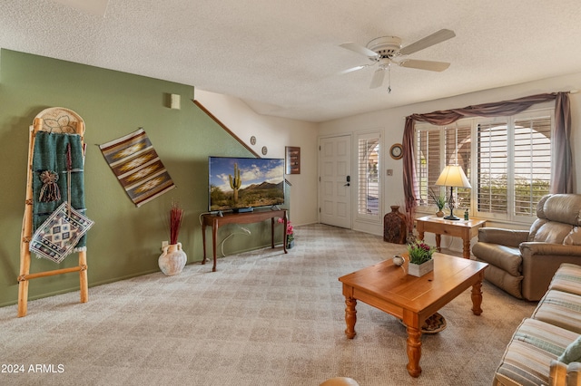 living room featuring a textured ceiling, light colored carpet, and ceiling fan