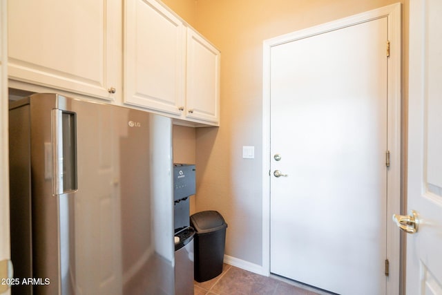 interior space with baseboards and light tile patterned flooring