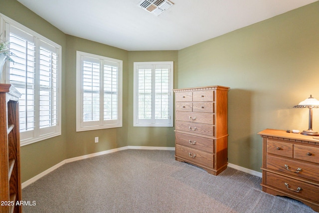 carpeted bedroom featuring visible vents, baseboards, and multiple windows