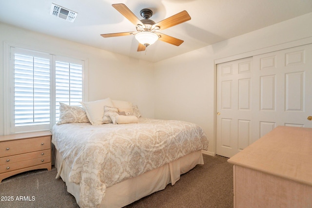 carpeted bedroom featuring visible vents, a ceiling fan, a closet, and multiple windows