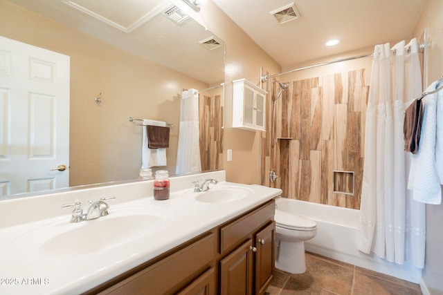 bathroom featuring shower / bath combo with shower curtain, a sink, visible vents, and toilet