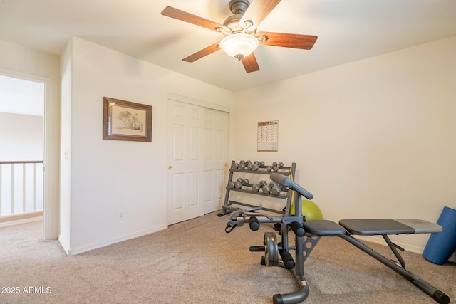 exercise room featuring baseboards, ceiling fan, and carpet