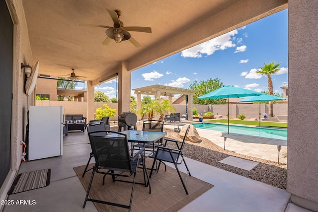 view of patio featuring a fenced backyard, a ceiling fan, a pergola, and a fenced in pool
