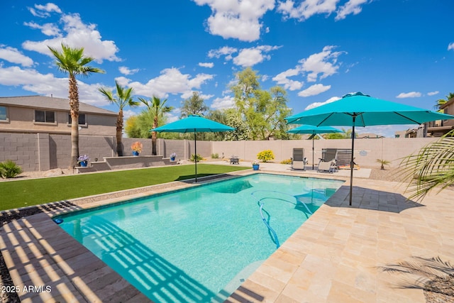 view of pool featuring a patio, a fenced backyard, a yard, and a fenced in pool