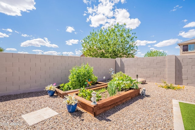 view of yard with a garden and a fenced backyard