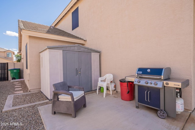 view of patio featuring fence, an outbuilding, and a shed
