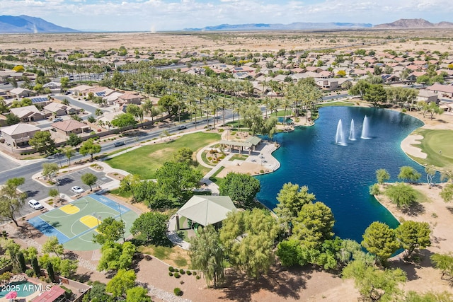 drone / aerial view with a water and mountain view and a residential view