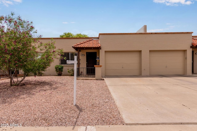 4501 E Carol Ave Unit 48, Mesa, AZ 85206 - view of front facade featuring a garage, a tiled roof, driveway, and stucco siding