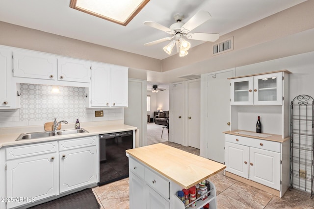 4501 E Carol Ave Unit 48, Mesa, AZ 85206 - kitchen with black dishwasher, a sink, a ceiling fan, tasteful backsplash, and white cabinetry