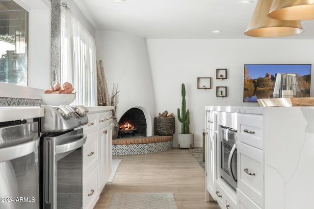 interior space with a large fireplace and light hardwood / wood-style flooring