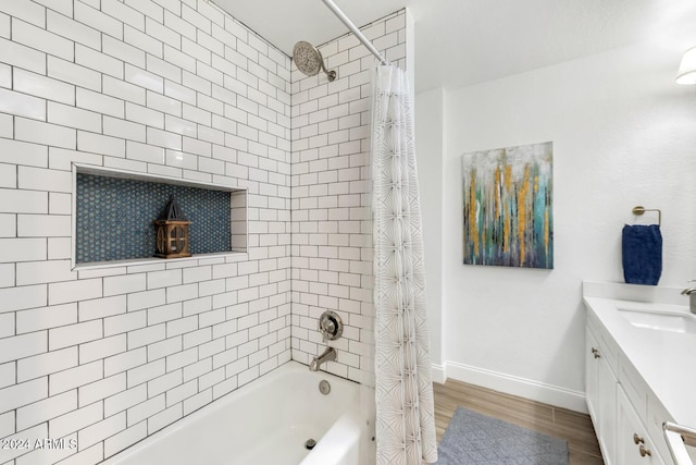 bathroom featuring vanity, hardwood / wood-style flooring, and shower / bath combo with shower curtain