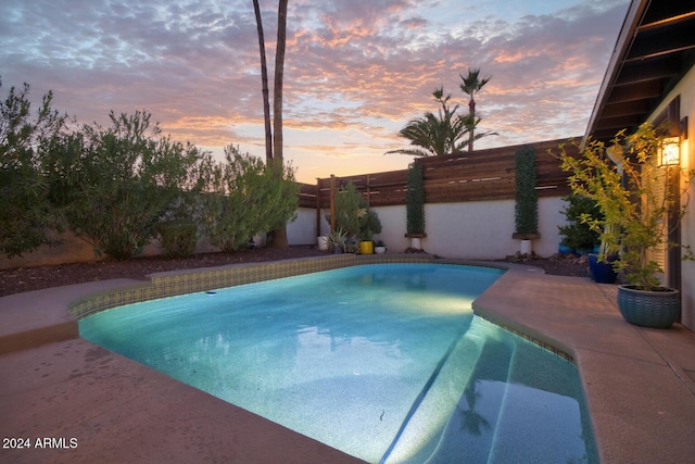 view of pool at dusk