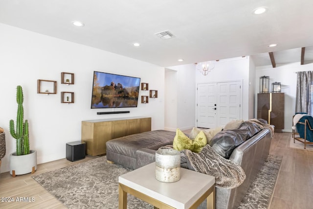 living room featuring a notable chandelier and light hardwood / wood-style flooring