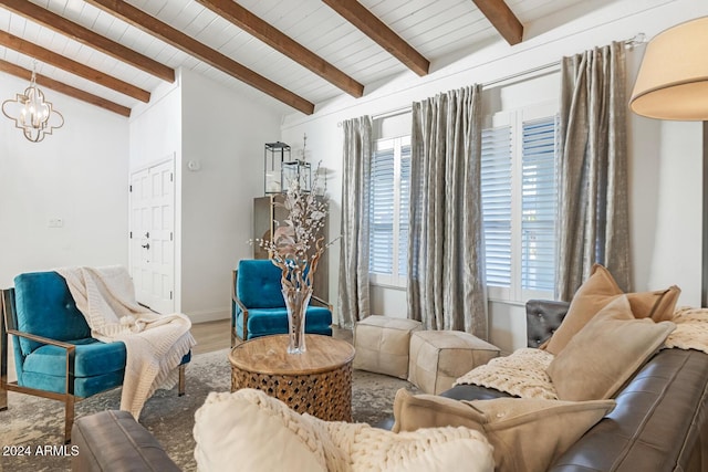 living room featuring hardwood / wood-style floors, vaulted ceiling with beams, a healthy amount of sunlight, and a notable chandelier