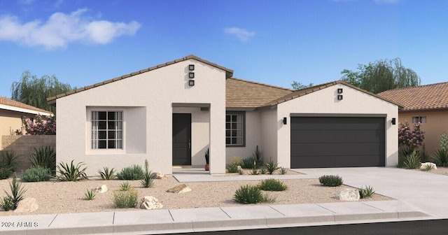 view of front of house with a garage, driveway, a tiled roof, and stucco siding