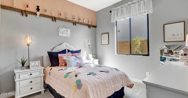 bedroom featuring light colored carpet