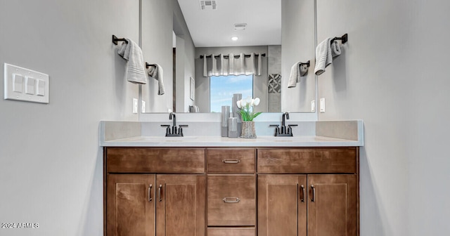 full bath with double vanity, visible vents, and a sink