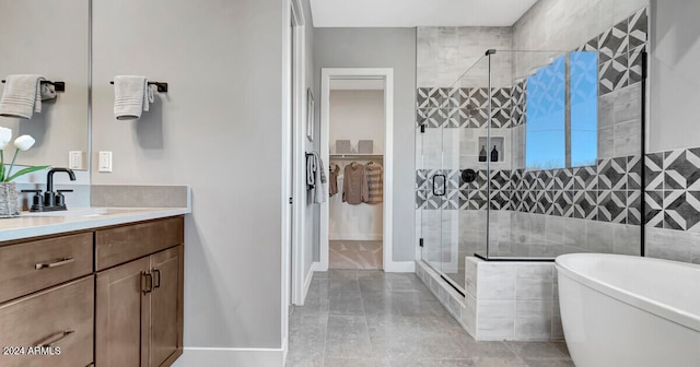 bathroom with vanity and independent shower and bath