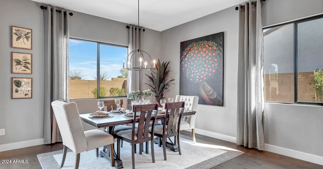 dining area featuring dark hardwood / wood-style floors and a chandelier