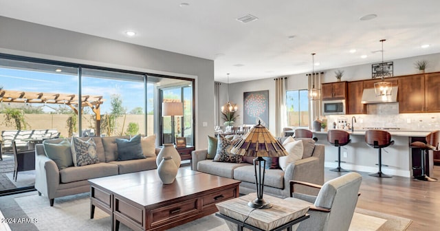 living room featuring light hardwood / wood-style flooring and sink