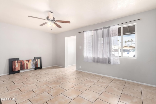 tiled spare room featuring ceiling fan