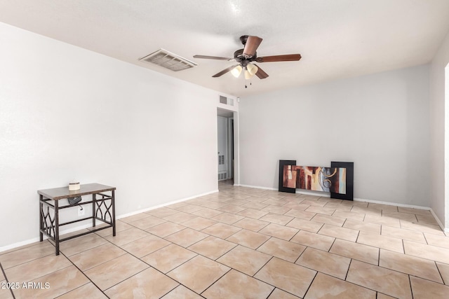 tiled empty room featuring ceiling fan