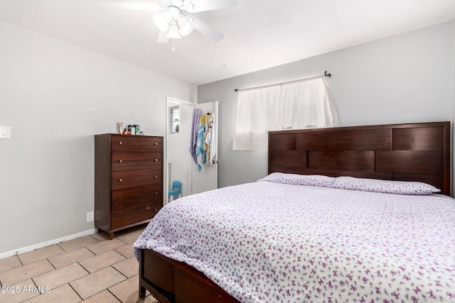 tiled bedroom featuring ceiling fan