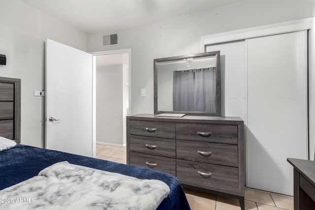 tiled bedroom featuring a closet