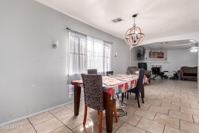 tiled dining area featuring an inviting chandelier