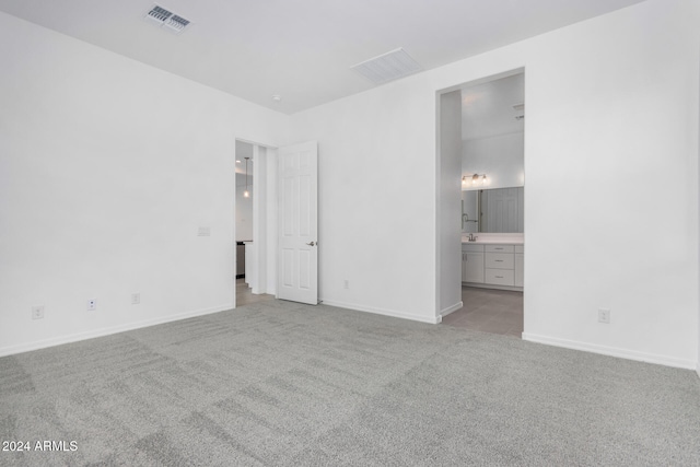 empty room featuring light colored carpet