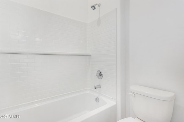 bathroom with toilet and tiled shower / bath combo