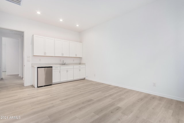 kitchen featuring sink, dishwasher, light wood-type flooring, and white cabinets