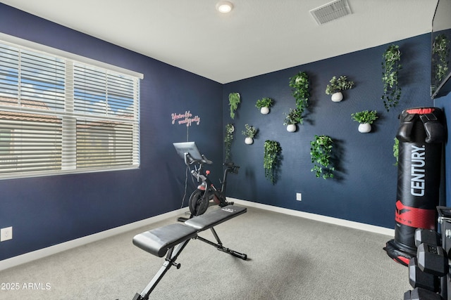 exercise area with carpet flooring, visible vents, and baseboards