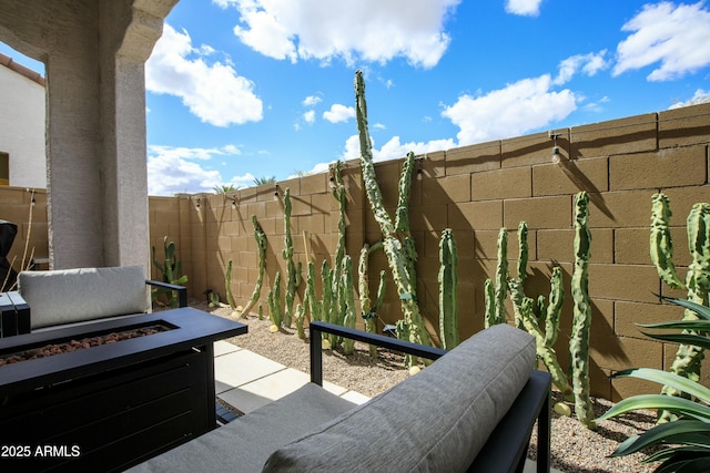 view of patio / terrace with a fenced backyard and a fire pit