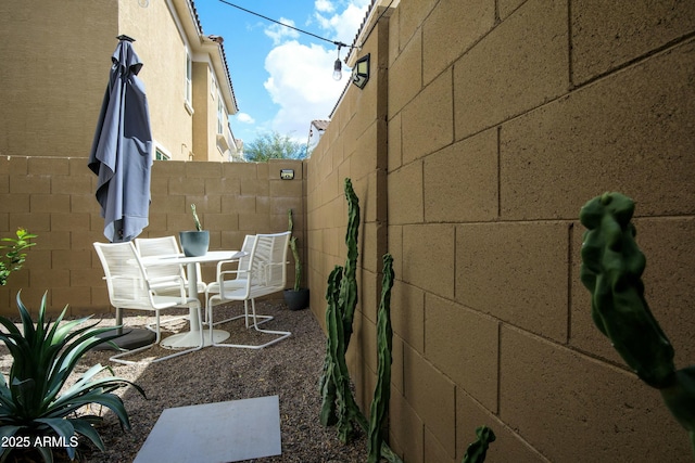 view of patio featuring fence