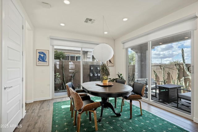 dining space featuring a wealth of natural light, visible vents, recessed lighting, and wood finished floors