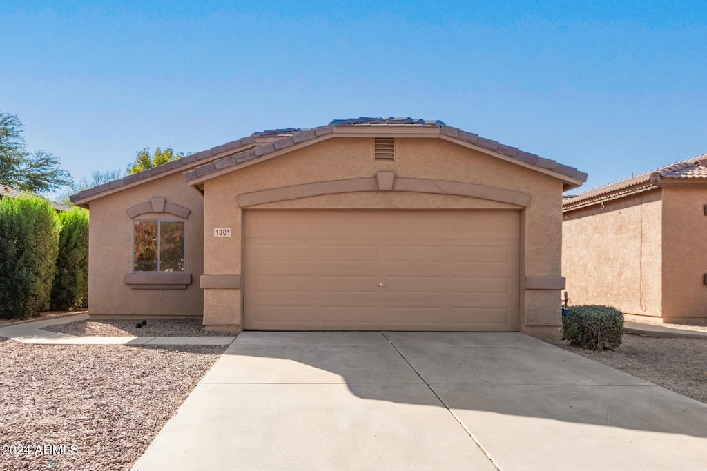 ranch-style home featuring a garage