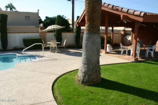 view of swimming pool with a gazebo, ceiling fan, a patio, and a lawn