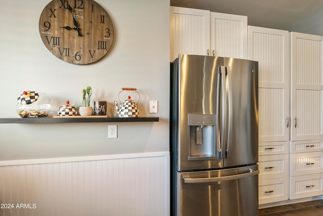 kitchen featuring white cabinets, stainless steel refrigerator with ice dispenser, and dark hardwood / wood-style flooring