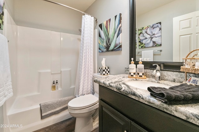 full bathroom featuring shower / bathtub combination with curtain, hardwood / wood-style flooring, vanity, and toilet