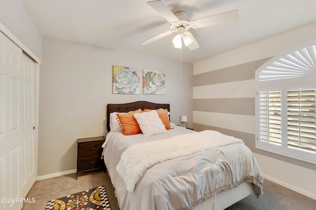 carpeted bedroom featuring ceiling fan and a closet