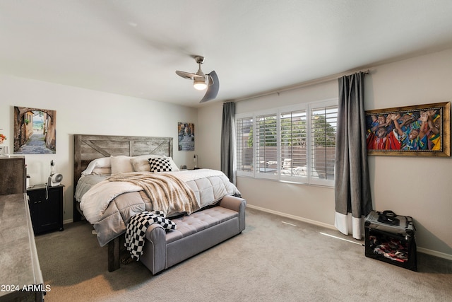 bedroom featuring ceiling fan and light colored carpet