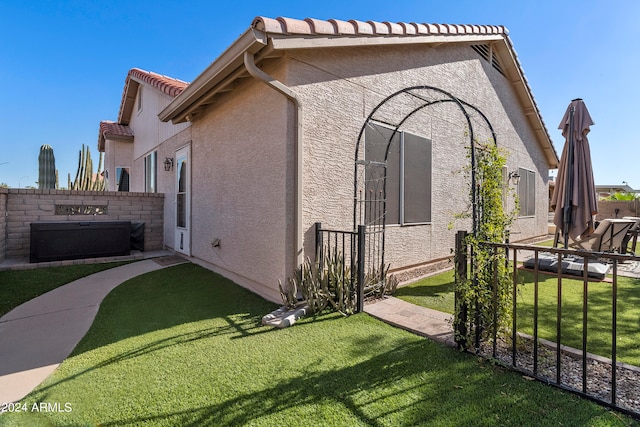 view of home's exterior with a lawn