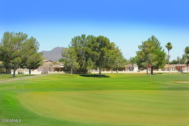 view of property's community featuring a yard and a mountain view