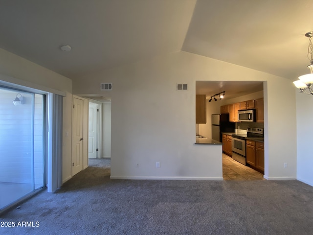 interior space featuring carpet floors, visible vents, vaulted ceiling, and an inviting chandelier