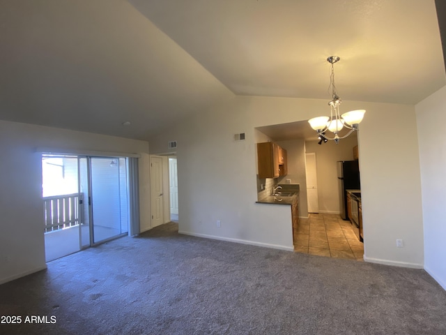 unfurnished living room featuring lofted ceiling, light carpet, a sink, visible vents, and an inviting chandelier