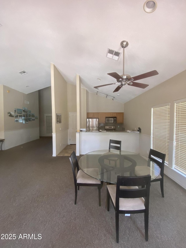 carpeted dining area with lofted ceiling, visible vents, and a ceiling fan